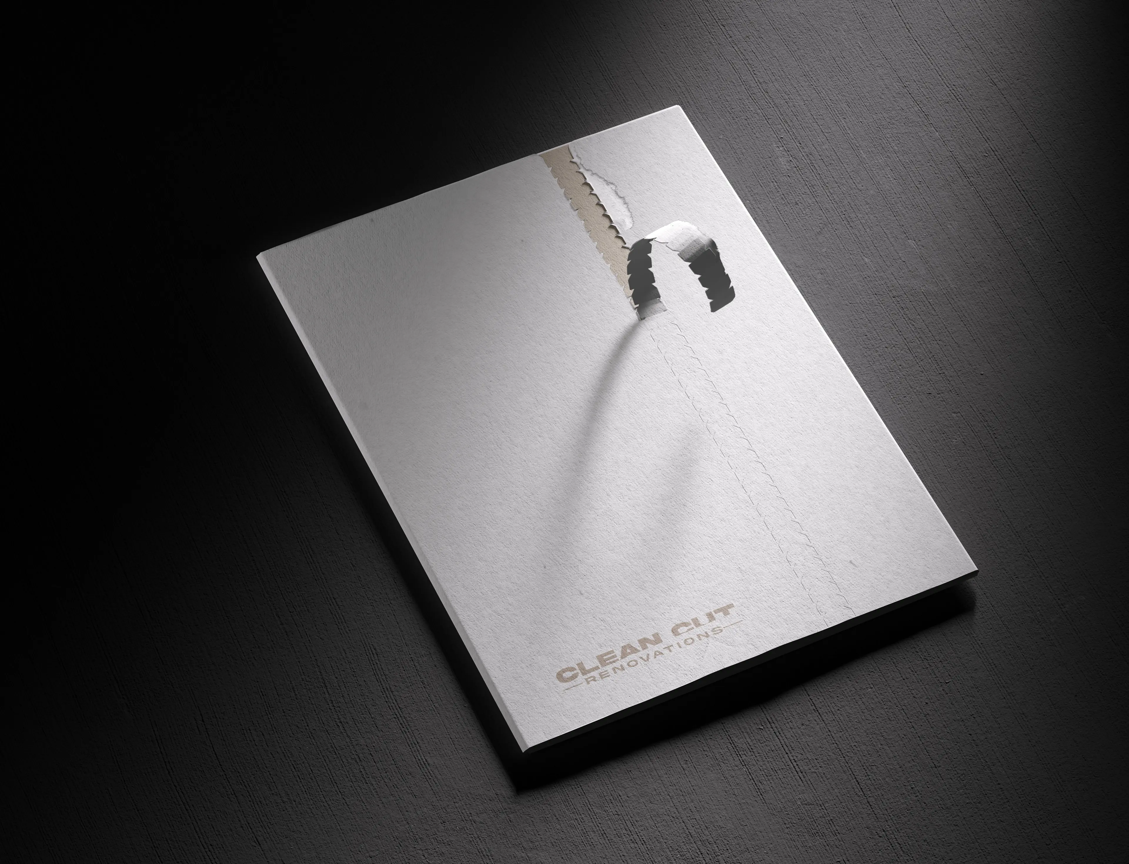 Clean Cut Renovations brand collateral folder with torn paper effect revealing brand identity