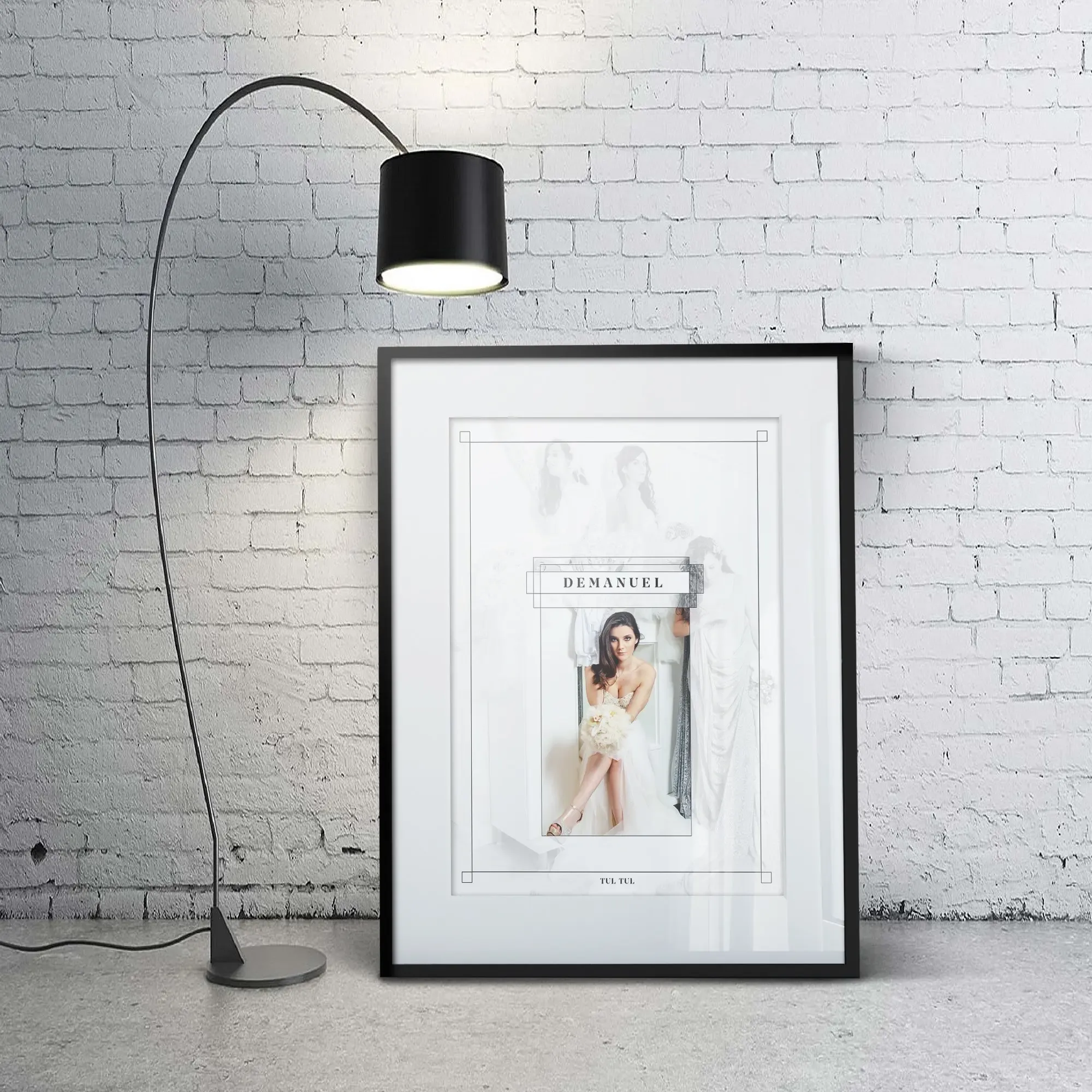 Demanuel TUL TUL brand poster mockup showing the logo framing an editorial bridal photograph, displayed in a black portrait frame against a white brick wall
