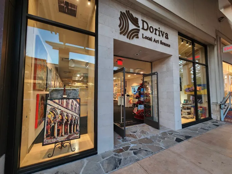 Doriva gallery storefront angle showing original paintings displayed in windows with branded signage above