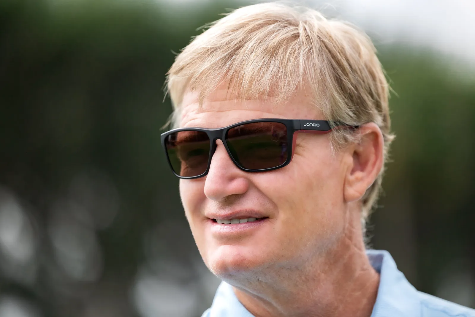 Golfer wearing JondoSport sunglasses on a golf course, lifestyle photography from the DMS web design and SEO project