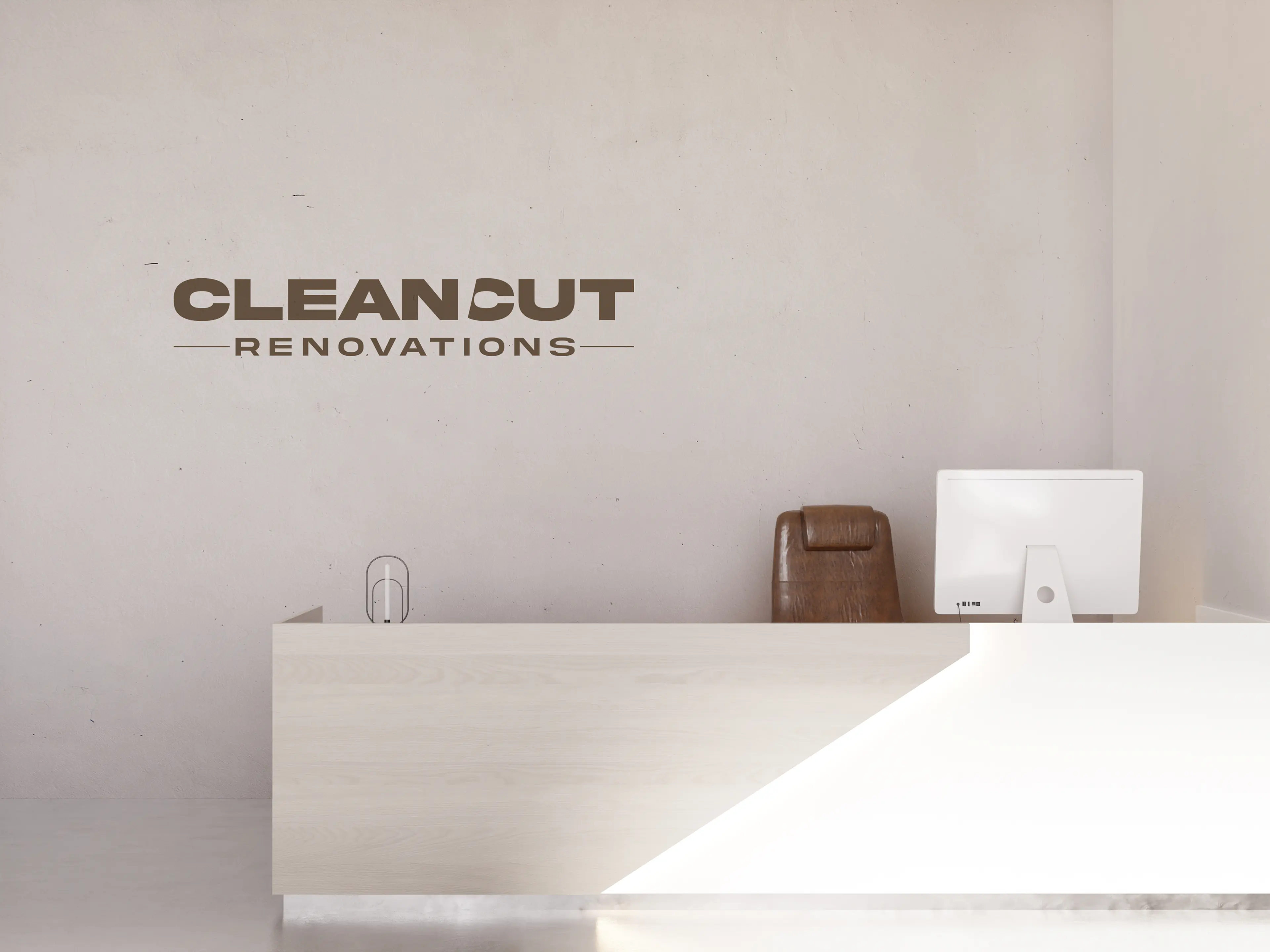 Clean Cut Renovations logo mounted on minimalist office wall above reception desk