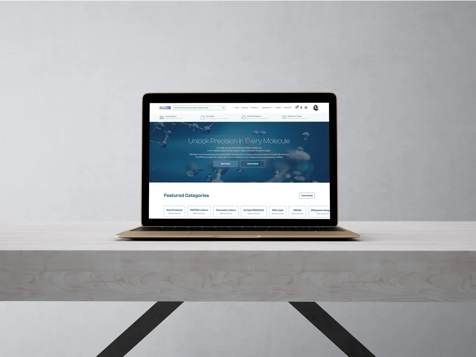Gold laptop on a minimalist white desk displaying the PurePEG pharmaceutical e-commerce homepage with a blue molecular hero banner, navigation bar, product category badges for PROTAC Linkers and PEG-Lipid, and a featured categories section